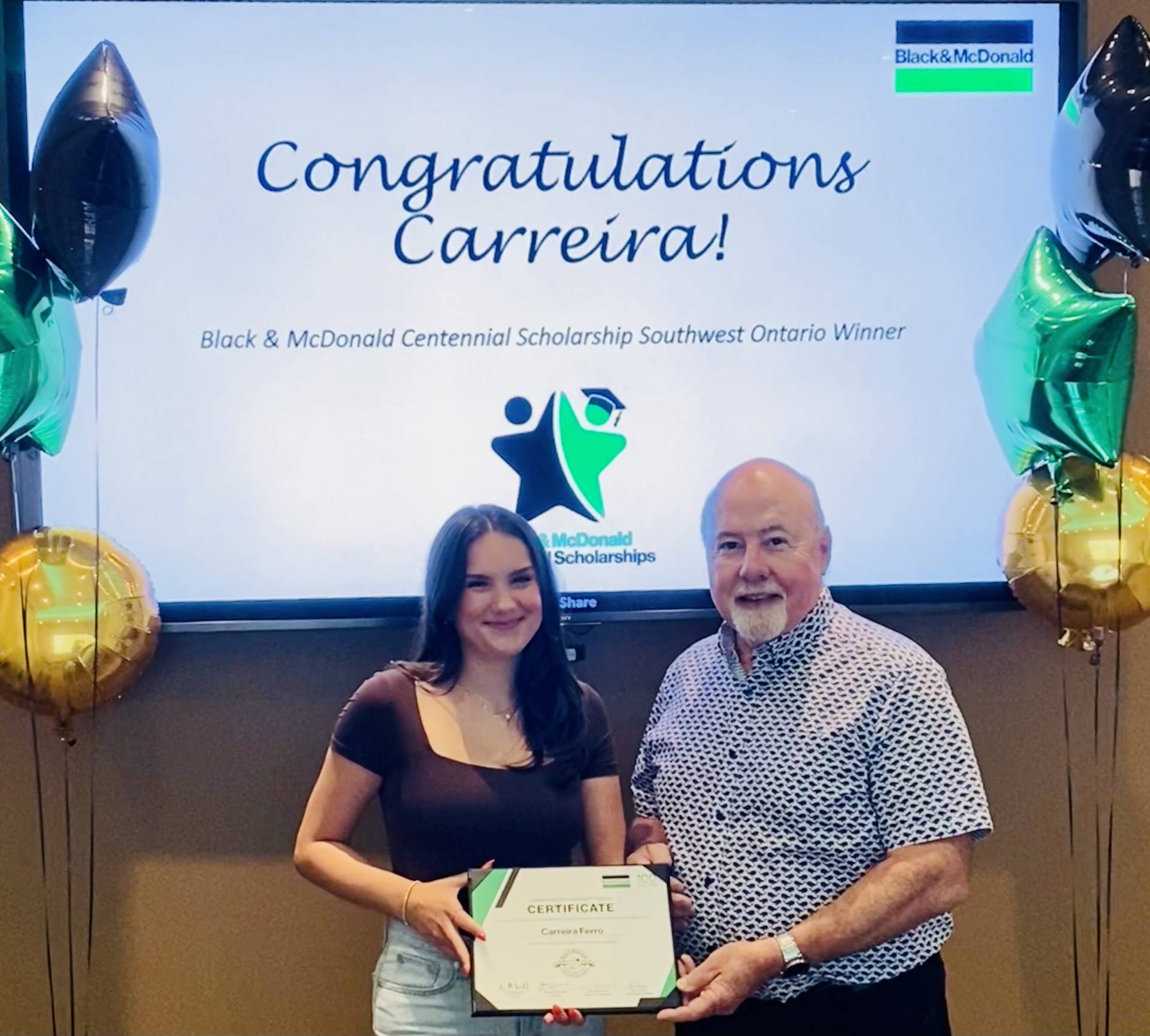 A scholarship recipient, and her father hold a certificate commemorating the Centennial Scholarships.